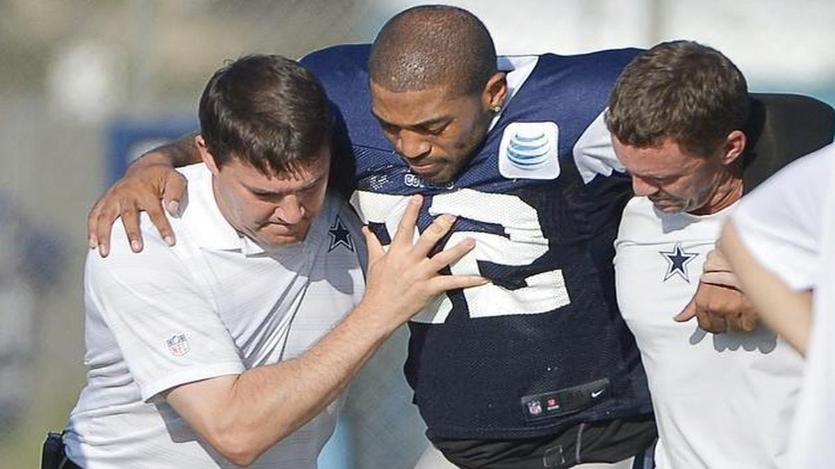 
Dallas Cowboys cornerback Orlando Scandrick (32) is lifted off the ground and placed on a cart after injuring his knee during practice at Cowboys Training Camp in Oxnard, CA, Tuesday, Aug. 25, 2015.
