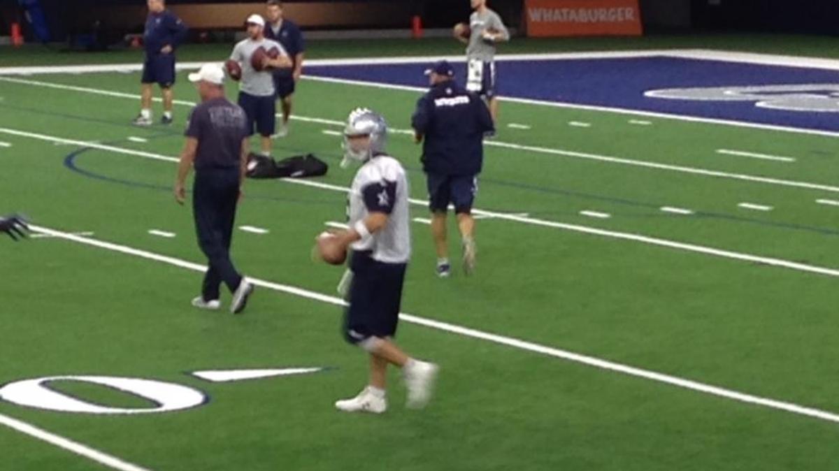 Cowboys quarterback Tony Romo put on shells and a helmet for practice Thursday.
