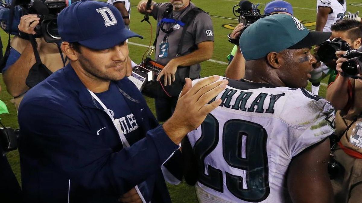 An injured Tony Romo, his left arm in a sling, gives former teammate and Eagles running back DeMarco Murray a pat on the back after the Cowboys defeated Philadelphia on Sept. 20.
