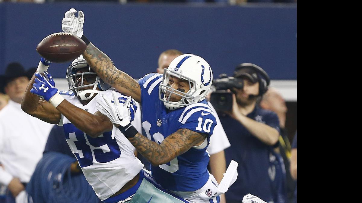 
Brandon Carr (left) breaks up a pass intended for Colts receiver Donte Moncrief last season.
