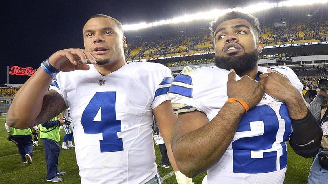 Dak Prescott, left, passed for 319 yards and two scores, while Ezekiel Elliott had 209 combined yards Sunday.