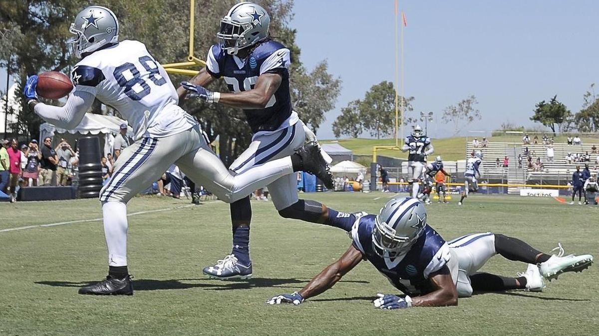 Cowboys receiver Dez Bryant hauls in a one-handed touchdown catch Thursday as cornerback Brandon Carr, center, and safety Byron Jones defend.