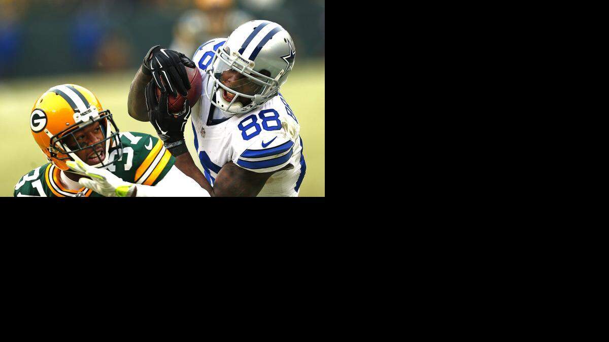 
Dallas Cowboys wide receiver Dez Bryant secures a catch over Green Bay Packers cornerback Sam Shields before stretch for the goal line on the way to the ground. The play was ruled a catch, but was overturned by replay officals.

