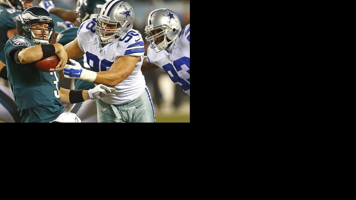 
Eagles quarterback Mark Sanchez, left, was sacked four times by the Dallas Cowboys defense. 
