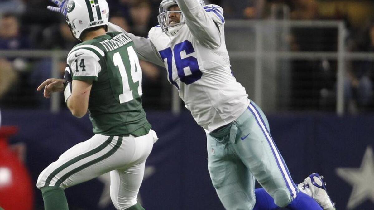 Greg Hardy, seen trying to block a pass Saturday night, participated in a coat drive earlier in the day.