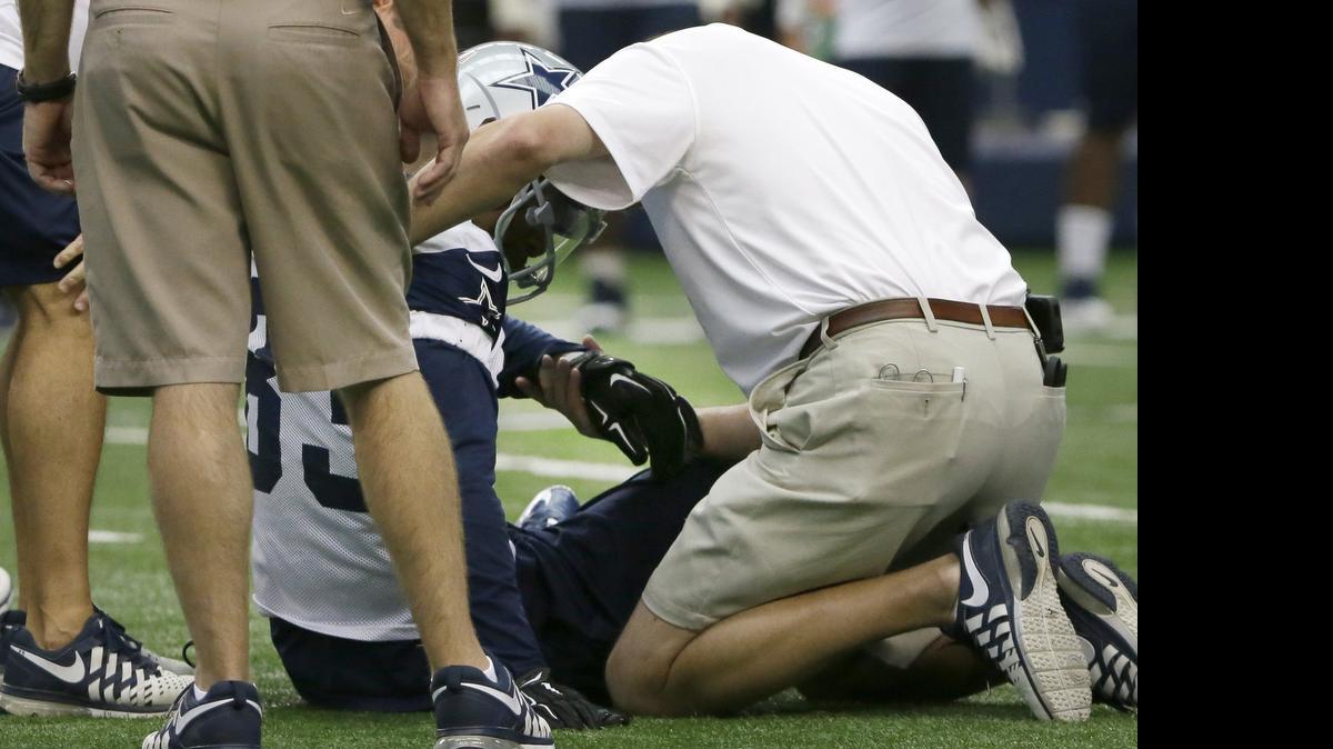 
Trainers check on Cowboys receiver Terrance Williams after he was injured in Thursday’s practice.
