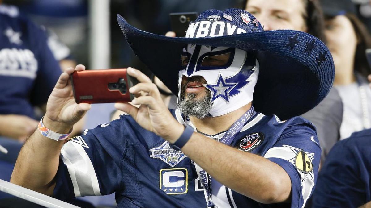 A Cowboys fan takes a picture during the first half of Thursday’s Hall of Fame preseason game between the Cowboys and Cardinals in Canton, Ohio.
