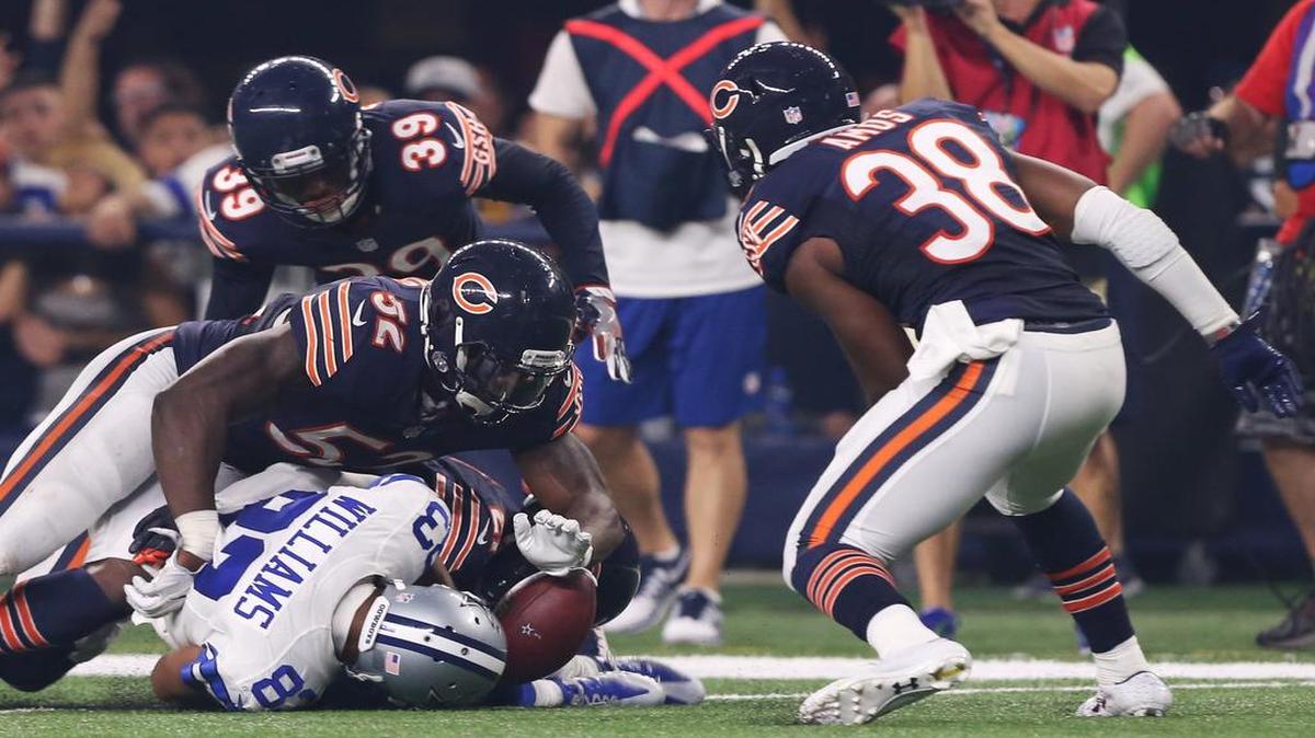 Cowboys receiver Terrance Williams fumbles the ball after a 47-yard catch before Bears safety Adrian Amos, right, recovers.