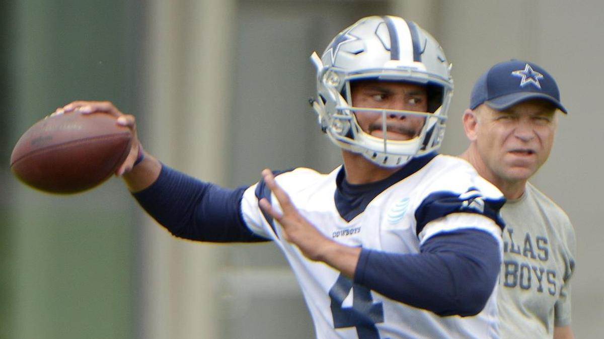 Dallas Cowboys offensive coordinator Scott Linehan keeps an eye on quarterback Dak Prescott mechanics and deameanor during practice.