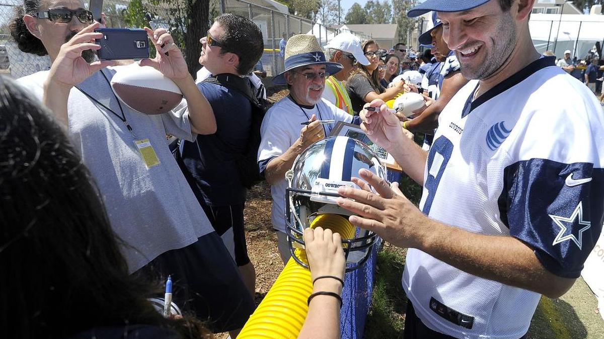
Dallas Cowboys quarterback Tony Romo (9) signs autographs at Cowboys Training Camp in Oxnard, CA, Wednesday, Aug. 26, 2015.
