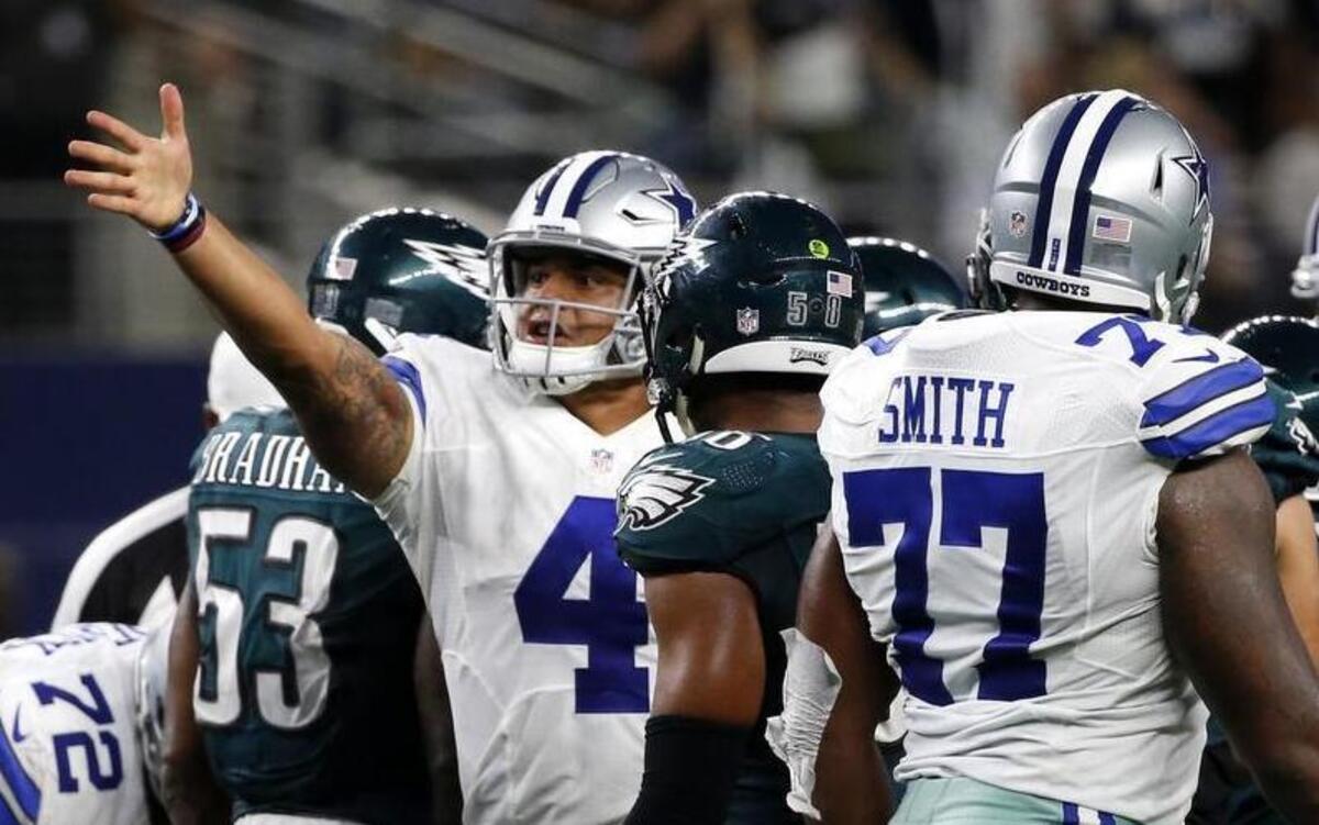Cowboys quarterback Dak Prescott signals the first down after a running play in overtime.