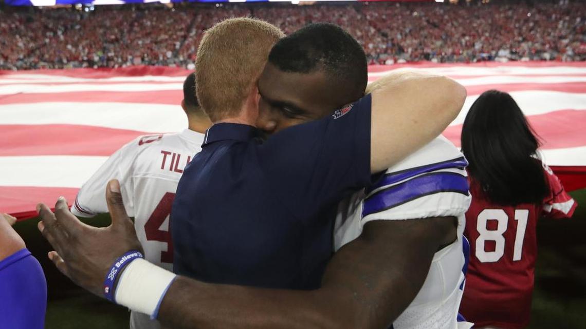 Jason Garrett and Dez Bryant embrace after national anthem on Monday.