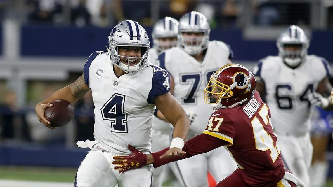 Dallas Cowboys quarterback Dak Prescott runs past Washington Redskins cornerback Quinton Dunbar for a short gain.