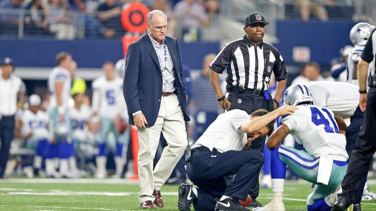 Dallas Cowboys head physician Dr. Daniel E. Cooper, left, is widely recognized as an authority in the field of sports medicine.
