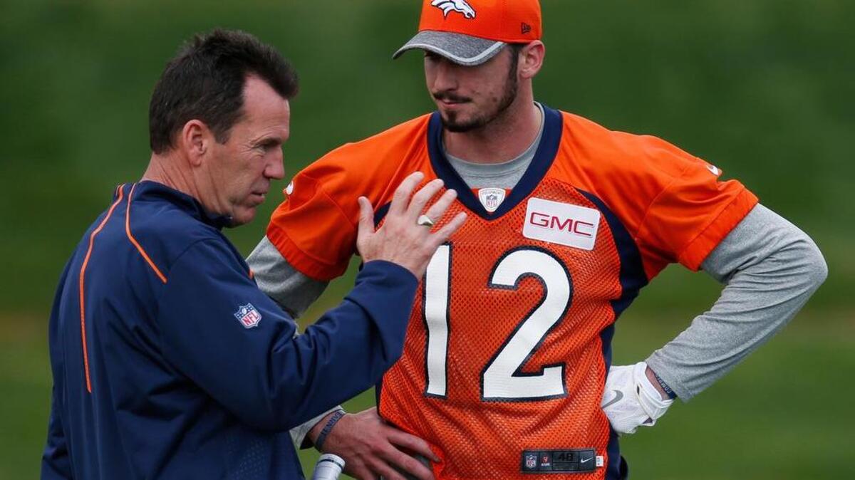 Denver Broncos head coach Gary Kubiak, left, confers with rookie quarterback Paxton Lynch during the team's NFL rookie camp football practice Friday, May 6, 2016, at the team's headquarters in Englewood, Colo. (