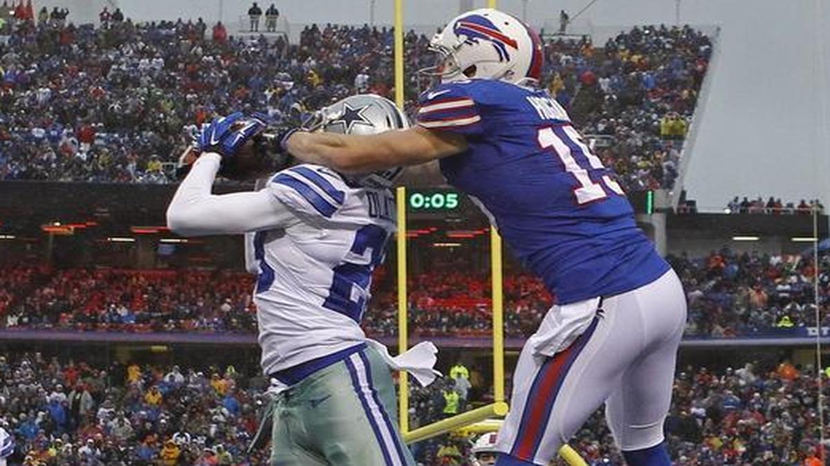 Cowboys cornerback Deji Olatoye intercepts a pass in front of Bills receiver Chris Hogan at the end of the first half, preserving a 6-6 tie.