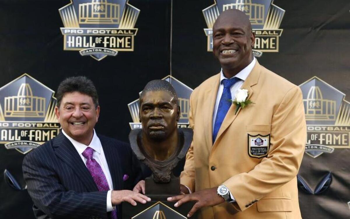 
Former Dallas and San Francisco great Charles Haley, right, poses with his bust, next to his presenter, former San Francisco 49ers owner Edward DeBartolo Jr., during inductions at the Pro Football Hall of Fame on Saturday.
