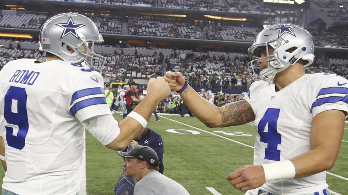 Dallas Cowboys quarterbacks Tony Romo and Dak Prescott exchange a fist-bump before the NFL divisional playoff football game against the Green Bay Packers Sunday, Jan. 15, 2017, in Arlington, Texas.