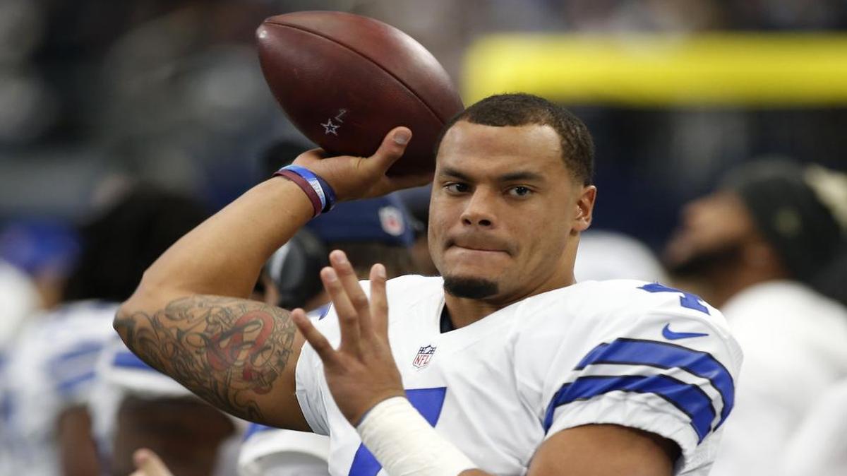 Dallas Cowboys quarterback Dak Prescott is drawing a lot of praise for picking up a cup on the sideline.