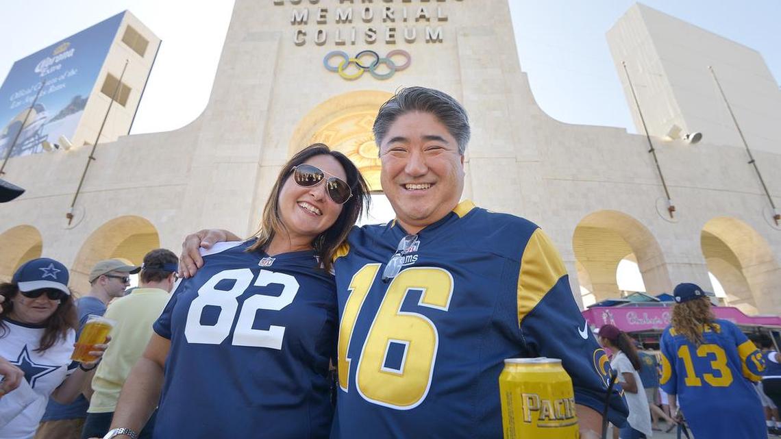 Denice and Bryon Tokunaga, Seattle, are a house divided, she Cowboys - he Rams, seen before the NFL preseason game at Los Angeles Memorial Coliseum on Saturday.