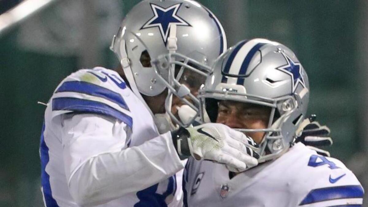 Cowboys quarterback Dak Prescott, right, celebrates with Dez Bryant after scoring on a 5-yard scramble in the third quarter Sunday night against the Raiders.