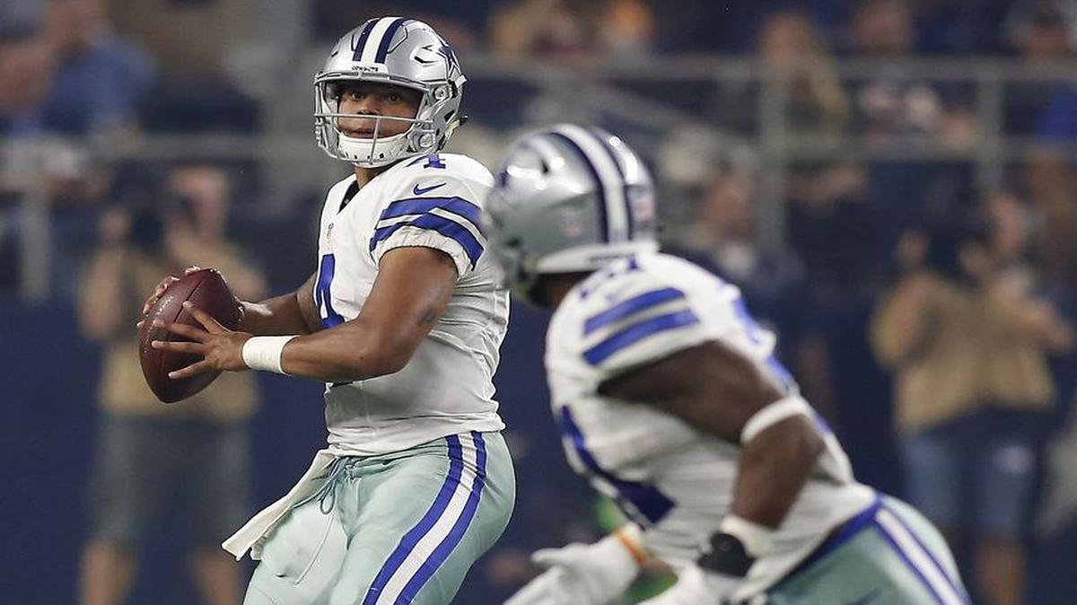 Dak Prescott, left, was almost flawless in completing 19 of 24 passes for 248 yards and his first touchdown.
