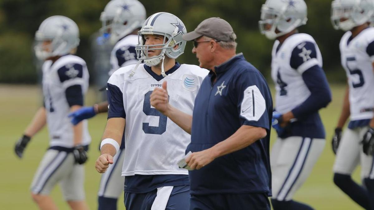 Tony Romo, shown talking with quarterbacks coach Wade Wilson, threw Wednesday but skipped Thursday as he eases his arm back into shape.