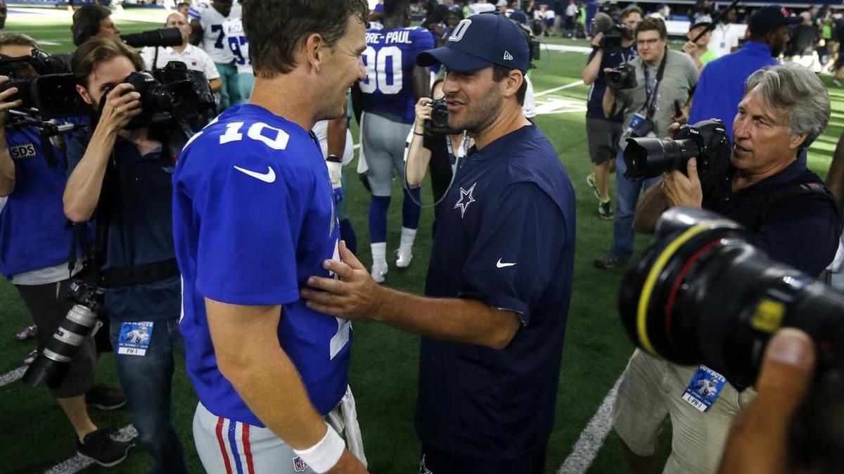 Cowboys quarterback Tony Romo talks to New York Giants quarterback Eli Manning after Sunday’s game.