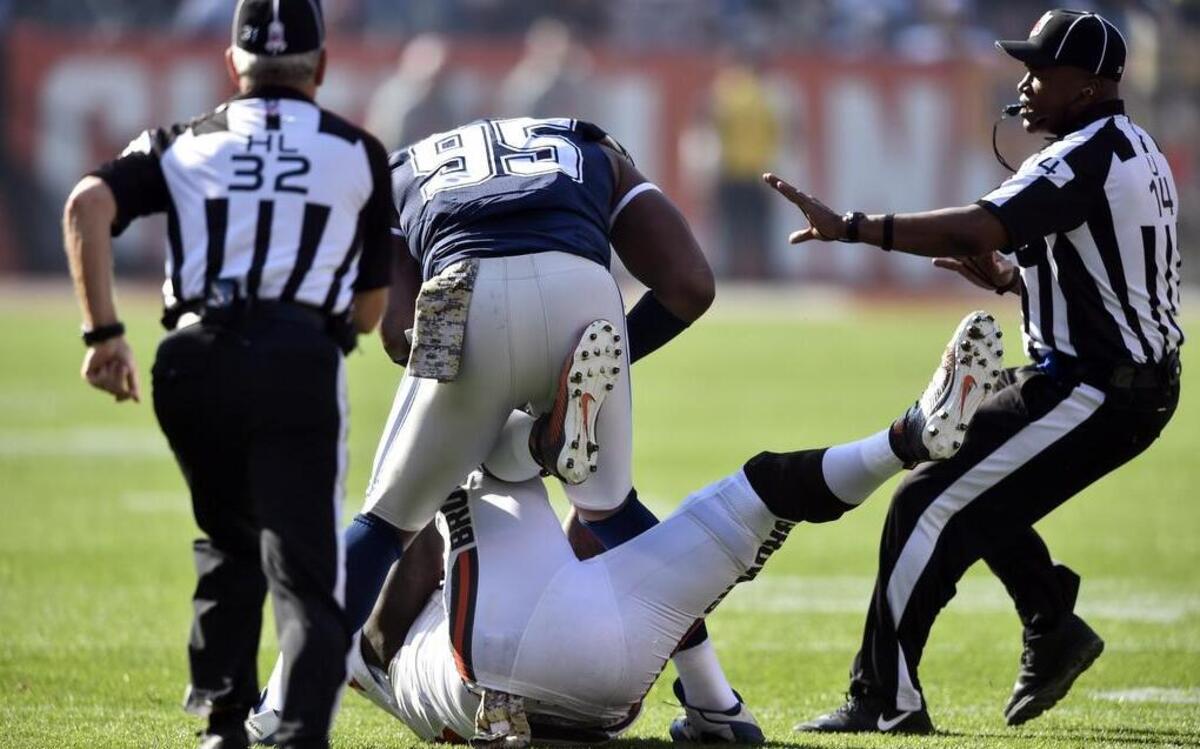 Dallas Cowboys defensive tackle David Irving knocks down Cleveland Browns center Cameron Erving during a fight in the first quarter. Both players were ejected.