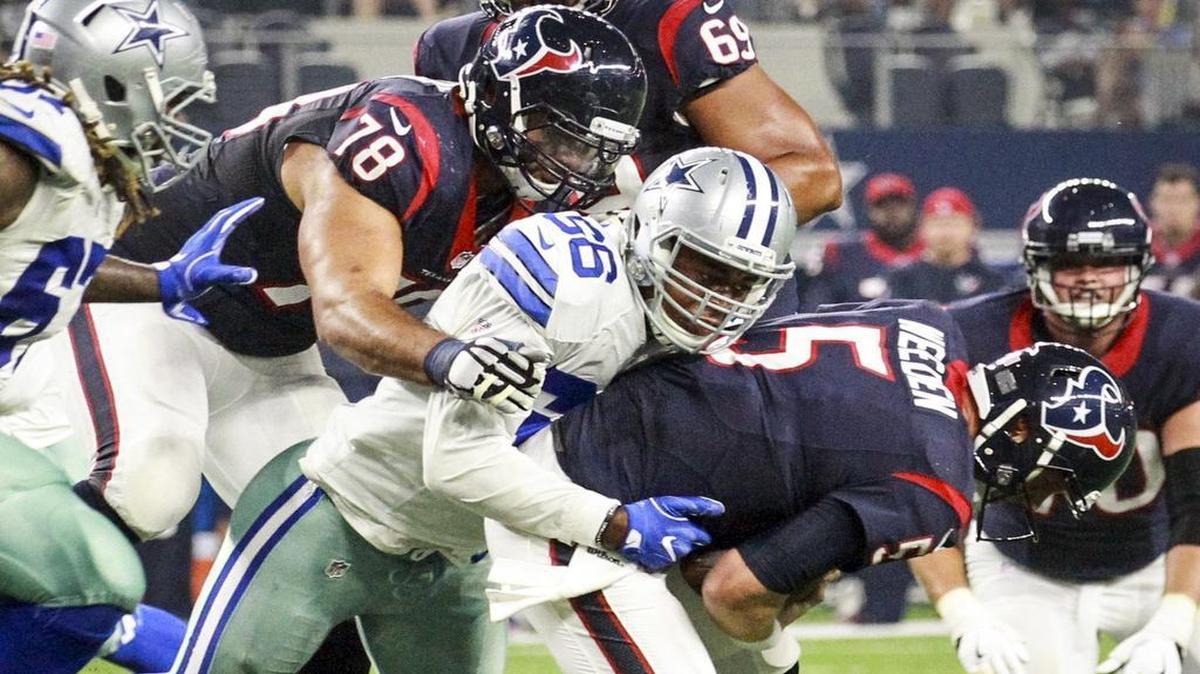 Cowboys’ Mike McAdoo, center, sacks Texans quarterback Brandon Weeden in the second quarter.