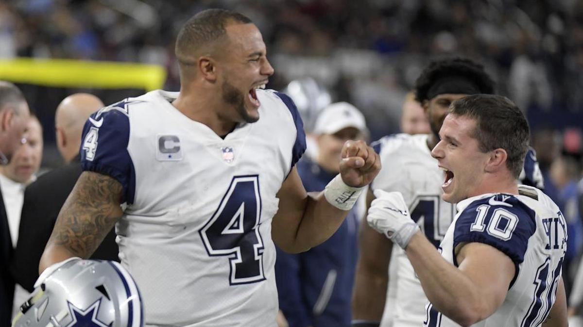 Dallas Cowboys quarterback Dak Prescott celebrates with wide receiver Ryan Switzer after Switzer's punt return .