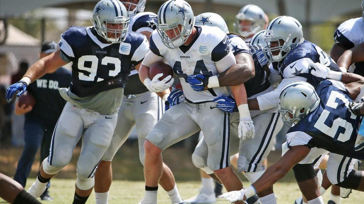 
Dallas Cowboys fullback Tyler Clutts (44) drags defenders with him during a recent practice.
