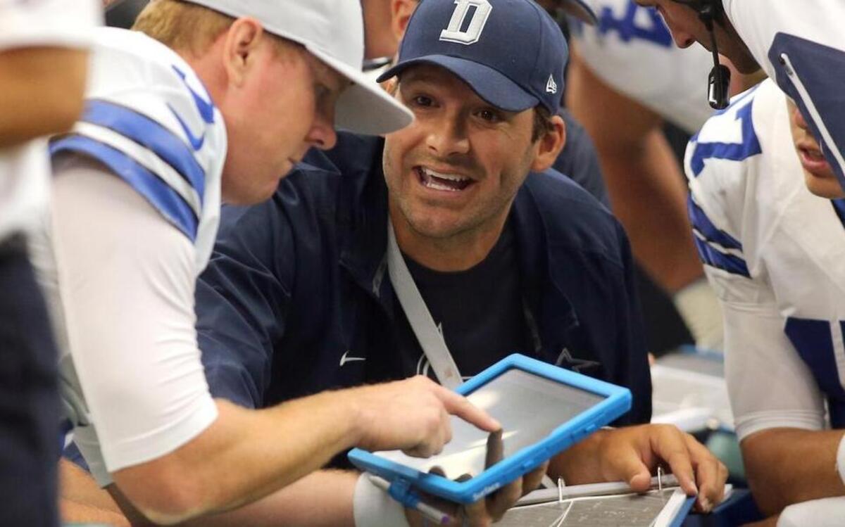 Dallas Cowboys quarterback Brandon Weeden and Tony Romo talk over strategy against Atlanta last season while using a Microsoft Surface tablet.