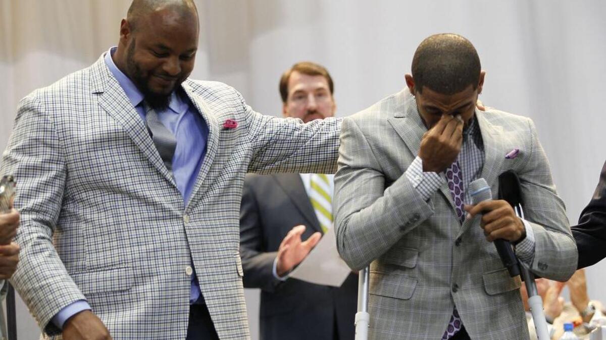 
Jeremy Mincey comforts the injured Orlando Scandrick as he tears up as they are awarded Defensive Players of the Year at the Dallas Cowboys Kickoff Luncheon at At&T Stadium, Wednesday, September 2, 2015. 
