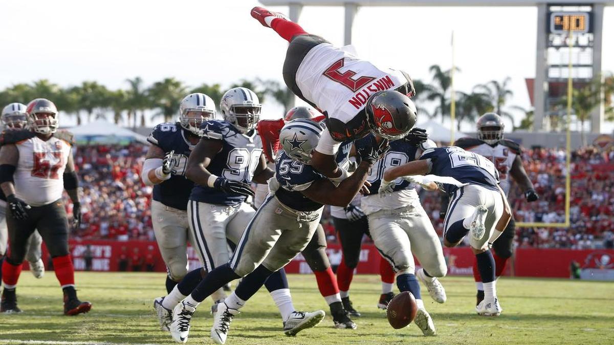 Tampa Bay Buccaneers quarterback Jameis Winston fumbles the football while leaping for the goal line, but a holding call negated the Dallas Cowboys’ end-zone recovery.