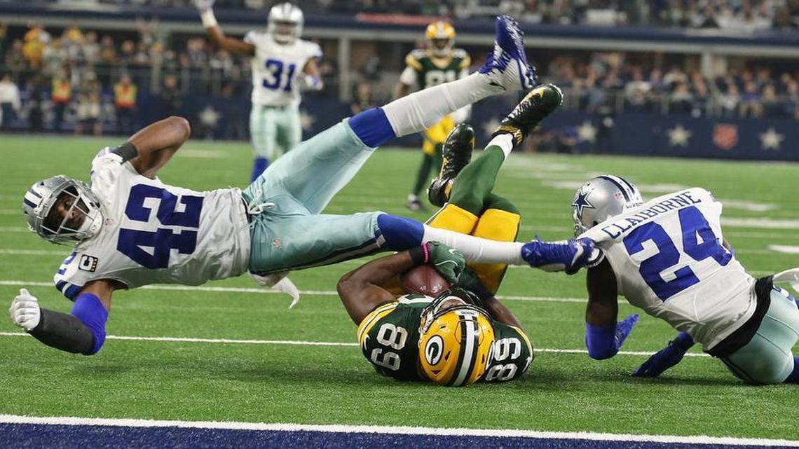 Green Bay Packers tight end Jared Cook (89) is hit by Dallas Cowboys strong safety Barry Church (42) and Morris Claiborne (24) as Green Bay plays Dallas in NFL divisional playoff in AT&T Stadium Sunday, Sunday, Jan. 15, 2017