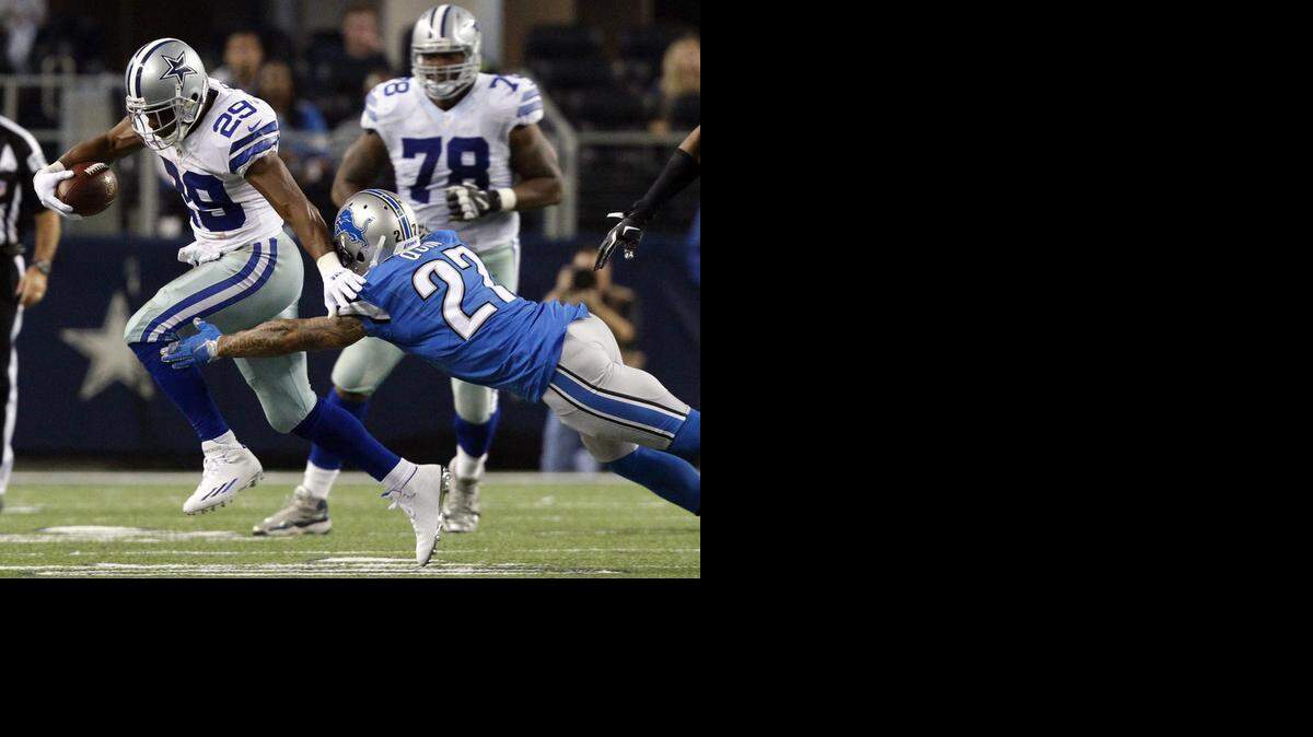 
DeMarco Murray runs past Lions free safety Glover Quin during the Cowboys’ playoff victory in January.

