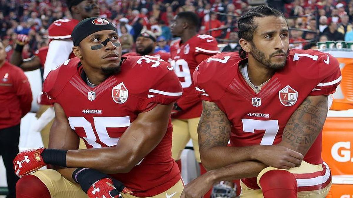San Francisco 49ers Eric Reid, left, and Colin Kaepernick take a knee during the national anthem prior to their season opener against the Los Angeles Rams on Sept. 12.