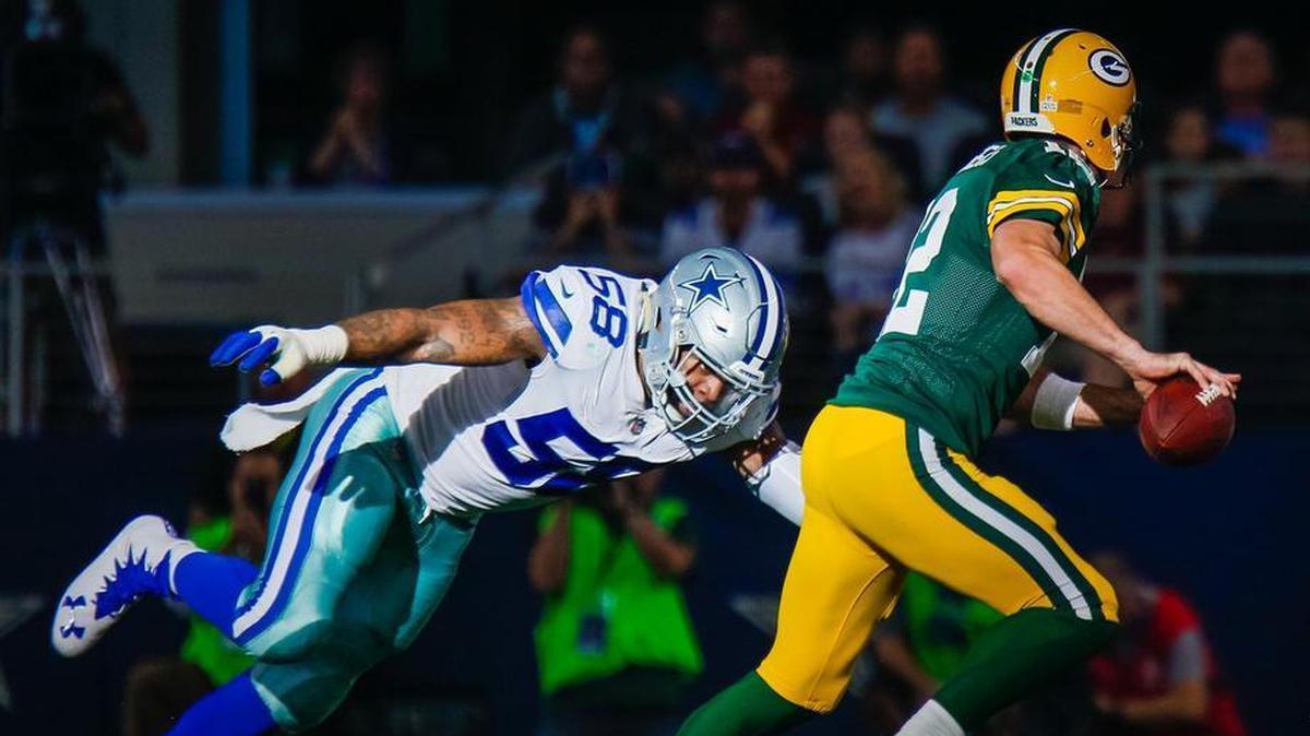 Damontre Moore, left, and the Cowboys’ defense have been a step slow most of this season including the loss to Aaron Rodgers and the Packers.