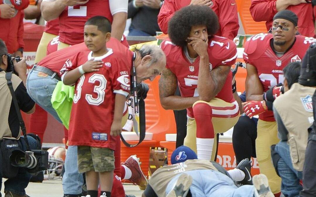 San Francisco 49ers quarterback Colin Kaepernick and free safety Eric Reid (35) take a knee during the national anthem Sunday.