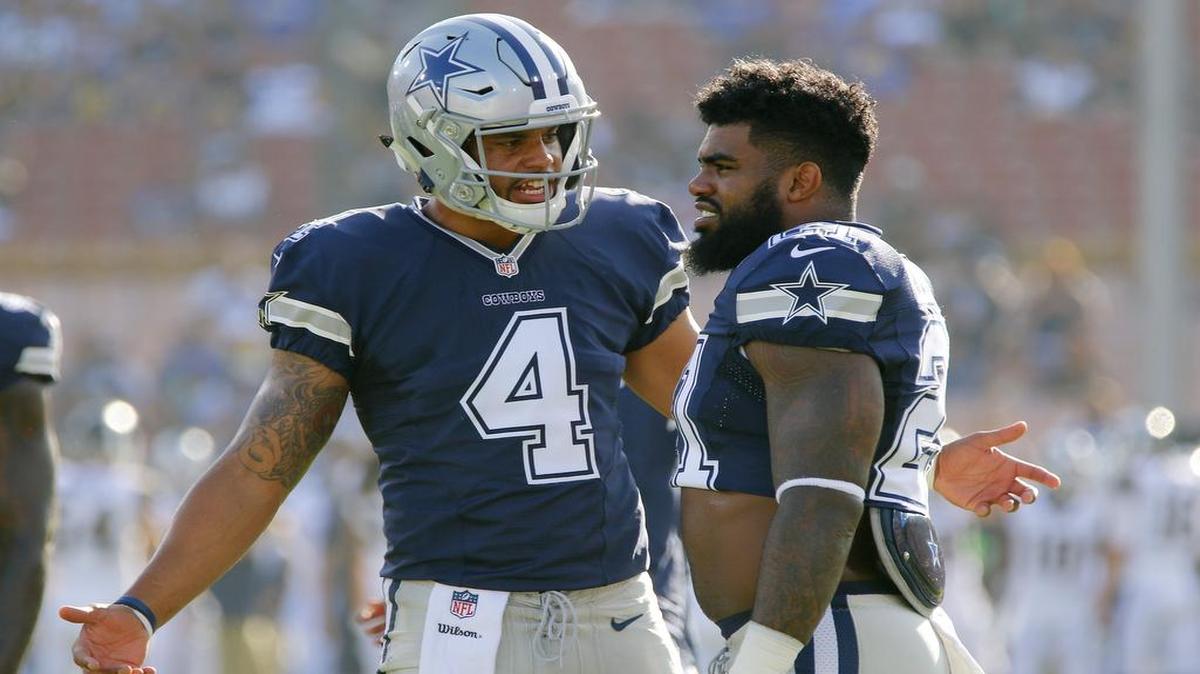 Cowboys quarterback Dak Prescott, left, and running back Ezekiel Elliott talk on the field before a pre-season game in Los Angeles. Both are coming off excellent rookie seasons.