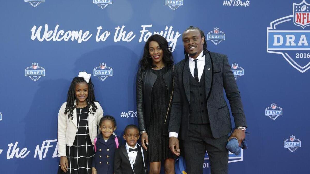 Brandon Carr poses for photos with his family at the NFL Draft last month.