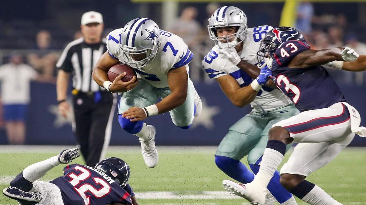 Dallas Cowboys quarterback Jameill Showers (7) goes airborne over Houston Texans defensive back Robert Nelson (32) on a first down run in the first quarter Thursday in a preseason game at AT&T Stadium in Arlington. Showers made the initial 53-man roster for the Cowboys on Saturday. The Cowboys are expected to add quarterback Mark Sanchez, who was cut by the Denver Broncos.