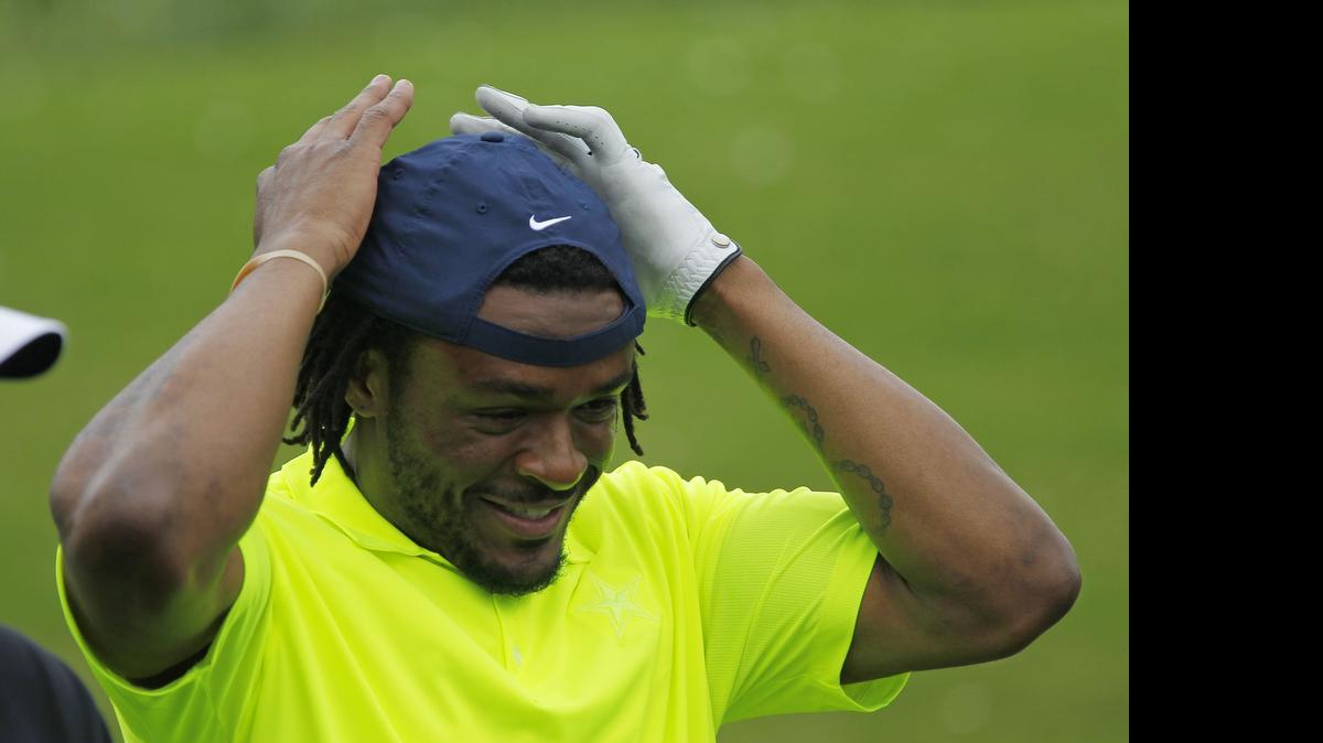 
Cornerback Brandon Carr adjusts his cap after teeing off at the Cowboys Golf Club on Wednesday.
