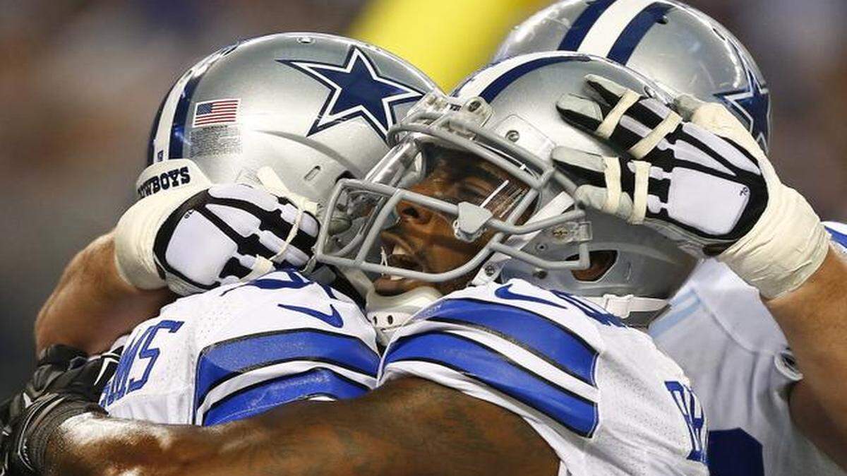 
Dez Bryant, center, and Zack Martin of the Dallas Cowboys congratulate Terrance Williams, left, on his first quarter touchdown against the Indianapolis Colts in Arlington, TX Sunday. 
