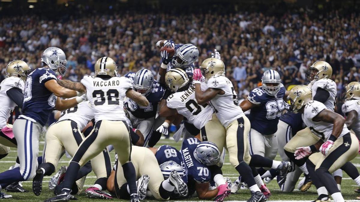 
Cowboys running back Joseph Randle (21) goes over the pile in the first half against the Saints, a play that drew the ire of coaches and got him benched briefly.
