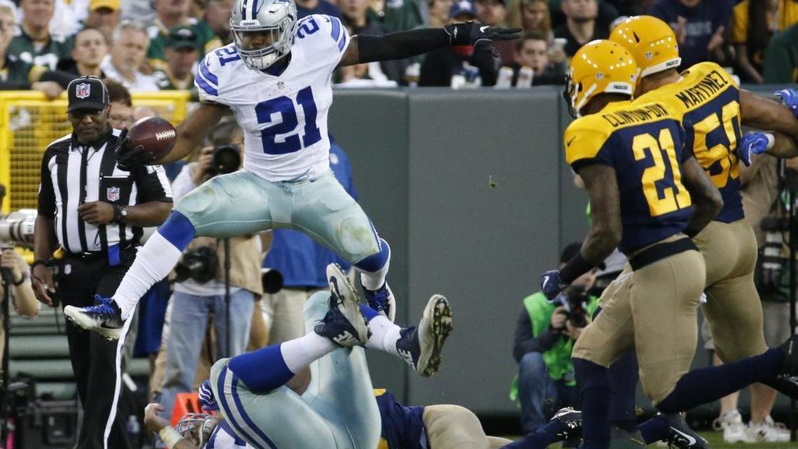 Cowboys rookie running back Ezekiel Elliott leaps over Green Bay defenders Sunday on his way to 157 yards, his fourth straight game with at least 130 yards.