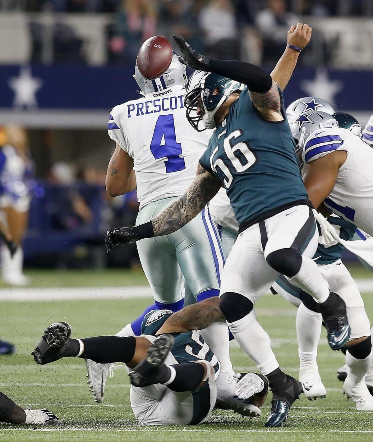 Dallas Cowboys quarterback Dak Prescott (4) has the ball stripped by Philadelphia Eagles defensive end Chris Long (56) in the second half of an NFL football game at AT&T Stadium in Arlington on Sunday Nov. 19. The play resulted in a fumble that was returned for a touchdown.