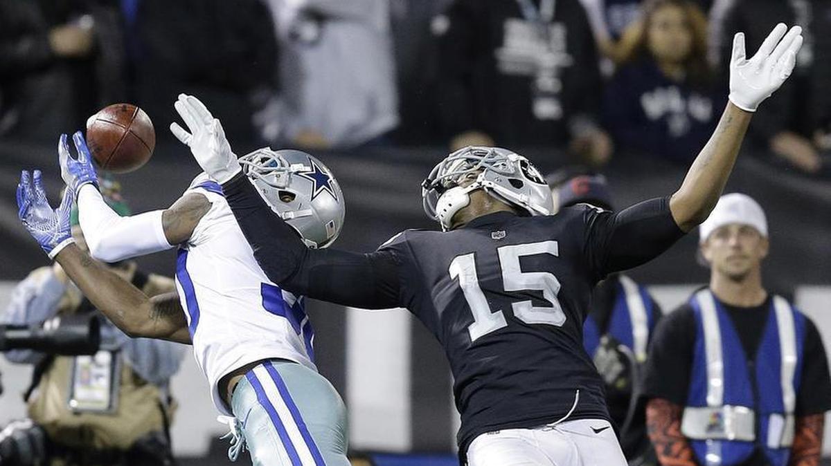 Dallas Cowboys cornerback Anthony Brown, left, breaks up a pass intended for Oakland Raiders wide receiver Michael Crabtree.