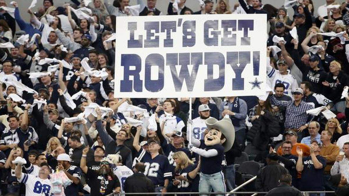 
Dallas Cowboys fans cheer during the first half of an NFL wild-card playoff game against the Detroit Lions. 
